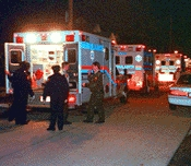 Emergency personnel load one of Banks' victims into an ambulance.